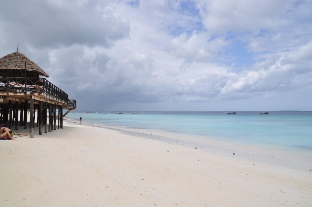 Traditional dhow boats on clear blue water at Nungwi Beach in Zanzibar, Tanzania